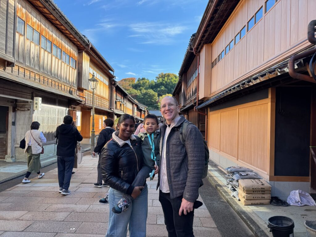 Tour guests walking through Nagamachi Samurai District in Kanazawa, with traditional samurai houses and stone-paved streets in the background