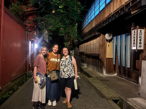 Local guide and guests on a night walking tour in Kanazawa