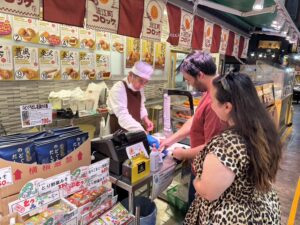 Kanazawa walking tour at Omicho Market with a local guide and guests enjoying seafood