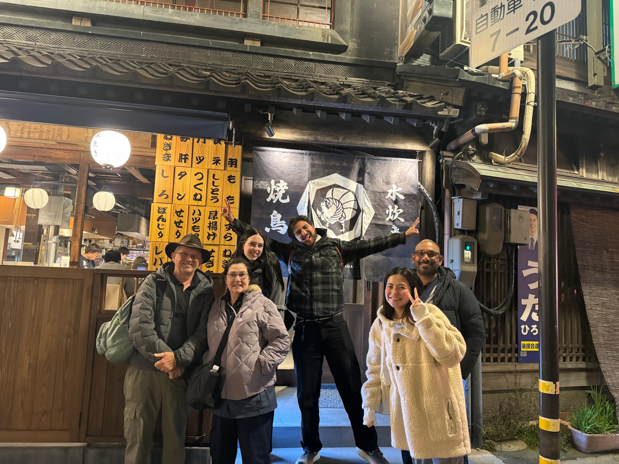 Amazing Tour Japan guide and guests outside a local izakaya during a Kanazawa night tour