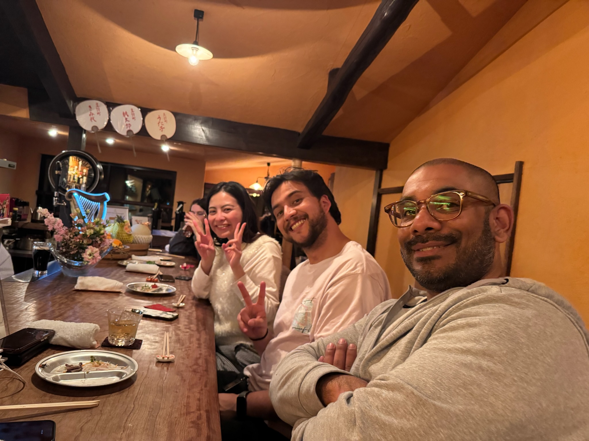International guests enjoying food and drinks inside a Kanazawa izakaya