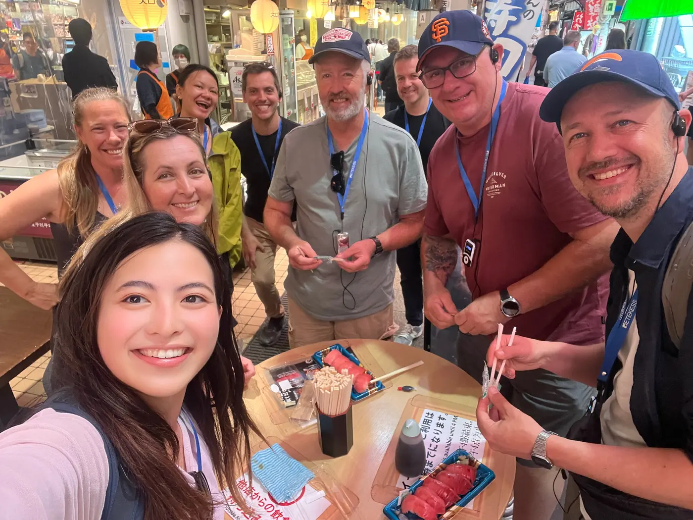 Amazing Tour Japan guide and international guests exploring Omicho Market in Kanazawa